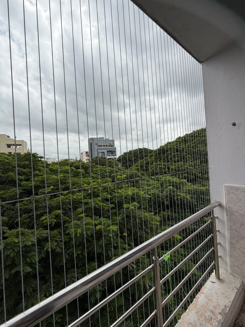 Invisible grill fitted on a balcony with an unobstructed green view