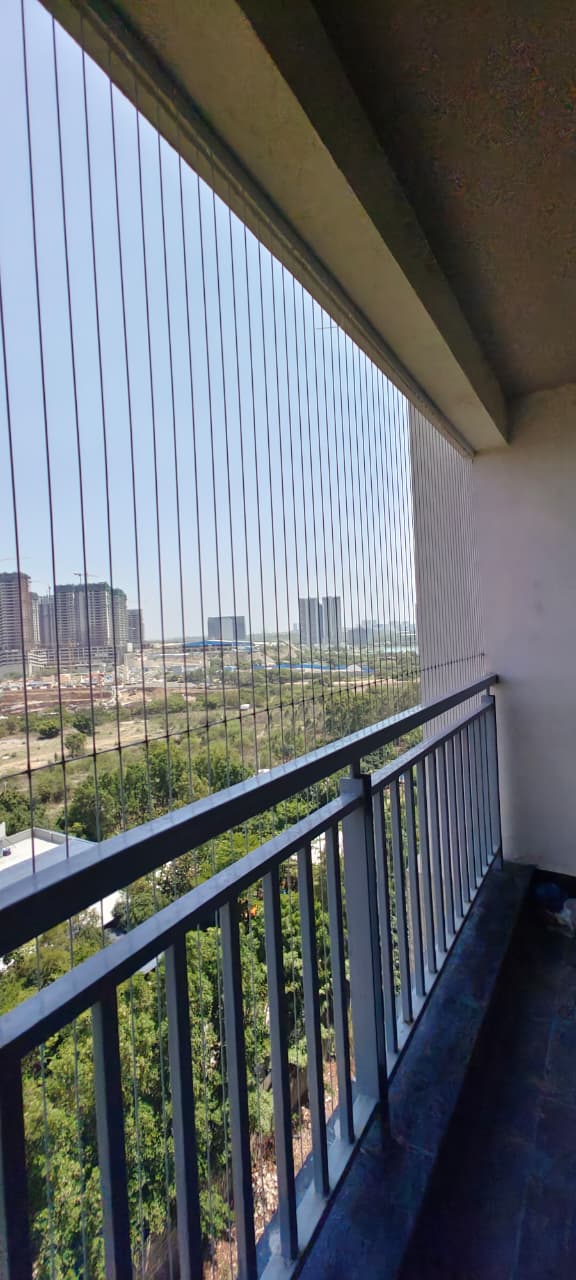 Invisible grill on a high-floor balcony with city skyline view