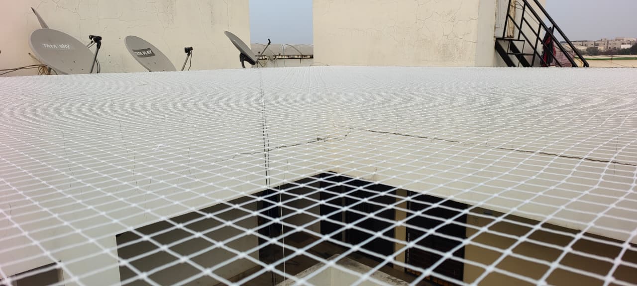 Open terrace shaft covered with a white safety net across the top
